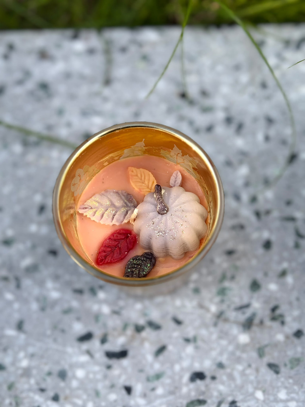 Golden Autumn Glow candle with pumpkin and leaf-shaped details viewed from above